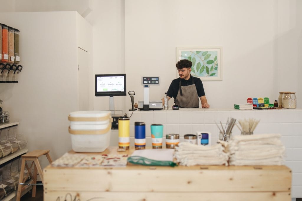 A man working the checkout counter at a store.